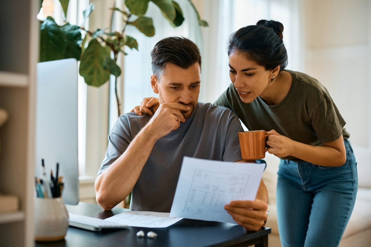 Mid Adult Couple Analyzing Their Home Finances At Home